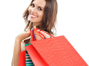 Young happy woman with shopping bags, isolated